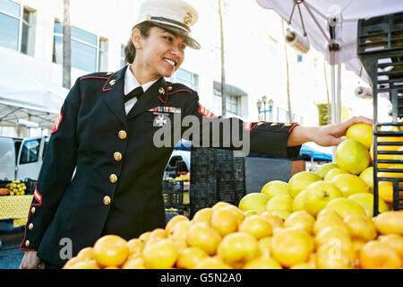 Asian soldier shopping in farmers market Stock Photo