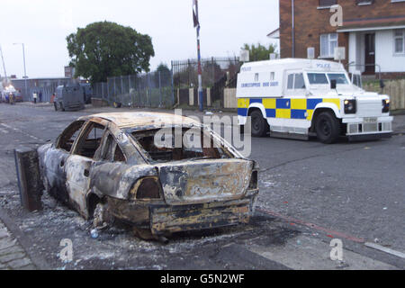 A burnt out police car on the Ardoyne Road after riots in the area last night in Belfast. A footpath row between two mothers sparked the new outbreak of sectarian violence which erupted in flashpoint North Belfast, police said. * Officers moved in to break up a confrontation after a Catholic mother on her way to collect her daughter from Holy Cross Primary School was challenged by a Protestant woman. It was then that trouble broke out, flaring into the worst street disorder in Belfast for several months. Stock Photo