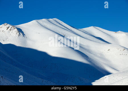 Snowy mountains in remote landscape Stock Photo