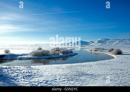 Snowy mountains and river in remote landscape Stock Photo