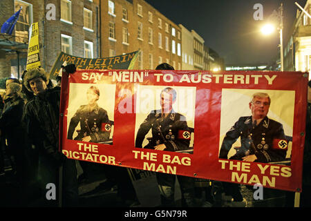 Protestors outside Leinster House, Dublin, as Finance Minister Michael Noonan delivers the 2013 Budget and Ireland braces itself for its sixth austerity budget in four years. Stock Photo