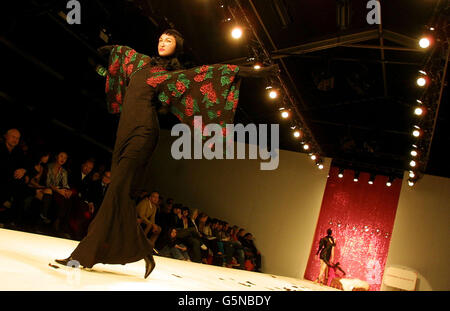 A model wearing a creation by designer Arkadius on the catwalk during the first day of London Fashion Week at the West Lawn Tent venue in the grounds of the Natural History Museum. Stock Photo