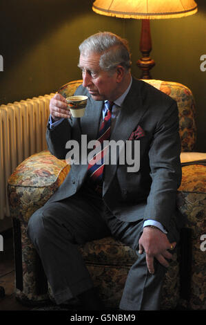 The Prince of Wales has tea in the living room of the birthplace of Dylan Thomas in Swansea. Stock Photo