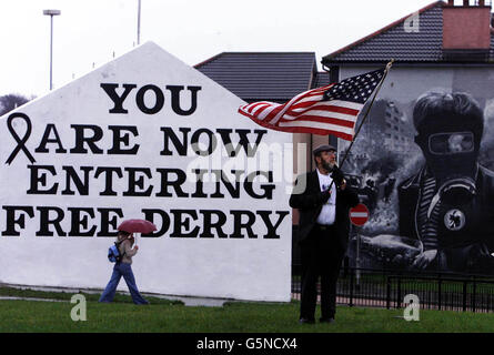 Irish American retired Police Chief, Jerry O'Keefe from Anaheim, California, holds up the American flag at Free Derry Corner, during the service to mark the 30th anniversary of Bloody Sunday in Londonderry. * ... Thousands of people gathered in Londonderry to retrace the ill-fated route of the Bloody Sunday march in 1972 where 13 people were shot dead by the Paratroop Regiment. Stock Photo