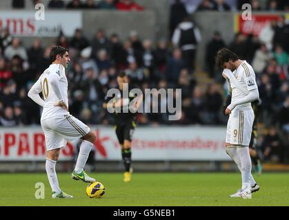 Swansea City's Miguel Michu (right) and Danny Graham stand dejected after Norwich City's Sebastien Bassong scores his side's second goal of the game Stock Photo