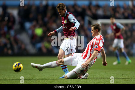 Aston Villa's Brett Holman is tackled by Robert Huth of Stoke City during the Barclays Premier League match at Villa Park, Birmingham. Stock Photo