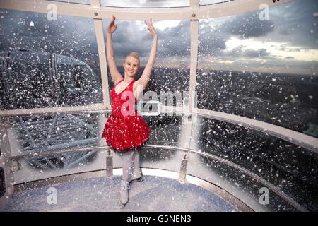 Charlotte Jeffery poses in a capsule of the EDF Energy London Eye which has taken on the appearance of a festive snow globe to celebrate the London Eye's Christmas offerings including Eyeskate. Stock Photo