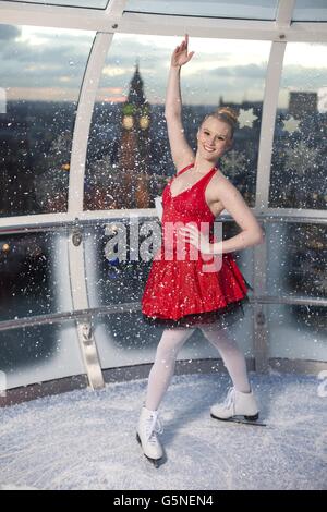 Charlotte Jeffery poses in a capsule of the EDF Energy London Eye which has taken on the appearance of a festive snow globe to celebrate the London Eye's Christmas offerings including Eyeskate. Stock Photo