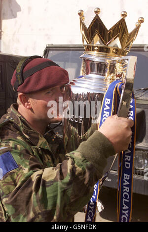 Corporal Steve Bell from Cirencester of 2 Para in Kabul, Afghanistan, gets to grips with the Barclaycard Premiership trophy. The trophy and Football Association ambassadors Lawrie McMenemy and Gary Mabbutt are in the war ravaged country on a morale boosting trip. * to organise a soccer match between ISAF (International Security Assistance Force) troops and Kabul FC at the Olympic Stadium this Friday, the stadium more infamous for the executions held there by the former Taliban regime than its sporting events. The army team is made up of soldiers from Great Britain, Italy, Germany and Holland. Stock Photo