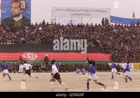 Action from a soccer match at the Olympic Stadium in Kabul, Afghanistan between ISAF (the International Security Assistance Force) and Kabul FC (in blue). The game was organised by the Football Association, the MoD and Barclaycard the new sponsors the Premiership. * Lawrie McMenemy and former Tottenham Hotspurs player Gary Mabbutt have spent two days in the war torn country coaching both teams. The ISAF side includes soldiers from Great Britain, Italy, Germany and Holland and played in the Olympic Stadium more infamous for the executions held there by the former Taliban regime than its Stock Photo