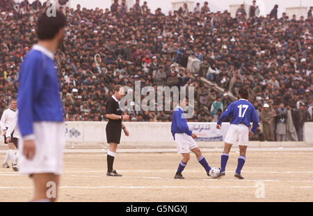 Kabul FC kick off a soccer match at the Olympic Stadium in Kabul, Afghanistan against ISAF (the International Security Assistance Force). The game was organised by the Football Association, the MoD and Barclaycard the new sponsors the Premiership. * Lawrie McMenemy and former Tottenham Hotspurs player Gary Mabbutt have spent two days in the war torn country coaching both teams. The ISAF side includes soldiers from Great Britain, Italy, Germany and Holland and played in the Olympic Stadium more infamous for the executions held there by the former Taliban regime than its sporting events. The Stock Photo