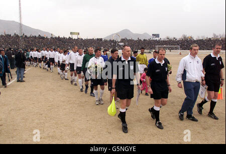 Football Association officials Pete Eastwood, Peter Jones, Keith Hill, and Andy Martin lead out the teams for a soccer match at the Olympic Stadium in Kabul, Afghanistan between ISAF (the International Security Assistance Force) and Kabul FC (in blue). * The game was organised by the Football Association, the MoD and Barclaycard the new sponsors the Premiership. Lawrie McMenemy and former Tottenham Hotspurs player Gary Mabbutt have spent two days in the war torn country coaching both teams. The ISAF side includes soldiers from Great Britain, Italy, Germany and Holland and played in the Stock Photo