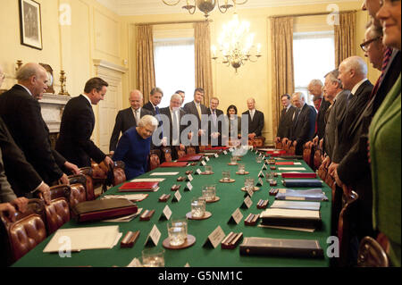 Queen Elizabeth II takes her seat as she attends the weekly cabinet meeting at 10 Downing Street in central London. Stock Photo