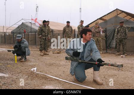 Members of the Afghan National Army, Afghan National Police and Afghan Uniform Police learn ways to detect improvised explosive devices (IEDs) at FOB Shawqat, Helmand Province, Afghanistan. Stock Photo