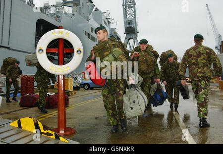 Royal Marines from Abroath based 45 Commando board HMS Ocean at Portsmouth Naval Base, prior to her departure for the Indian Ocean. The vessel will take over from HMS Illustrious as the UK flagship in the war against terrorism. Stock Photo