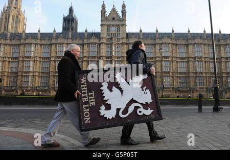 Members of the real ale group, Campaign for Real Ale (Camra), carry pub signs as they lobby Parliament to call for an end to the beer duty escalator, in Westminster today. Stock Photo