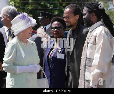 Britain's Queen Elizabeth II meets Rastafarians Ziggy Soul (2nd right) and Lloyd 'Juba' Johnson, at the Hugh Sherlock School Trenchtown, Jamaica, during her Jubilee overseas tour. Stock Photo