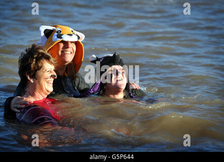 Annual New Year's Day swim in Clevedon. Swimmers dive in for the Annual New Year's Day swim at the Marine Swimming Lake in Clevedon, Somerset. Stock Photo