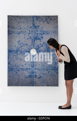 London, UK.  22 June 2016. A staff member looks at 'The Guild' by Anna Hughes at the annual exhibition of works by artists graduating from the UK's longest established art school, RA Schools Show, at the Royal Academy in Piccadilly.  Works from 17 emerging artists are on show 23 June to 3 July. Credit:  Stephen Chung / Alamy Live News Stock Photo