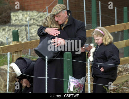 John Shakespeare, whose son Robert was killed in the Selby rail crash, comforts his widow Julie and daughters Laura (right) and Kerrie, centre, as they attend a Memorial Service for the victims of the crash at the scene of the accident, * to mark the first anniversary of the tragedy in which ten people lost their lives. Earlier today survivors and relatives of the victims met at the scene of the disaster for an act of remembrance. Around 25 people gathered at the Great Heck site in North Yorkshire at 6.15am - the exact time when the disaster occurred on February 28 last year. Stock Photo