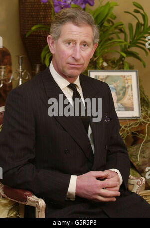 The Prince of Wales at his Highgrove home from where he paid a tribute to his 'darling grandmother', Queen Elizabeth the Queen Mother who died aged 101. The Prince, wearing a dark suit and black tie, was seated in the Orchard Room in an outbuilding of his Gloucestershire residence. *... with two framed photographs of the Queen Mother on a table behind him. Stock Photo