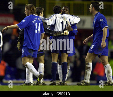 Former Chelsea player, now with Tottenham Hotspur Gustavo Poyet kisses Marcel Desailly after Chelsea won 4-0 against Spurs in the FA Cup Sixth Round at White Hart Lane, London. Stock Photo