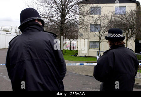 Police Officers stand by the murder scene on Church End estate in Harlesden, north-west London, which is being investigated after 15 year-old Somalian schoolboy Kayser Osman was found dead. * The boy's body was discovered yesterday and is thought to be the result of a stabbing, possibly following an argument over a football match. Stock Photo