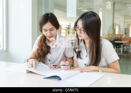 Two Asian students studying together at university Stock Photo