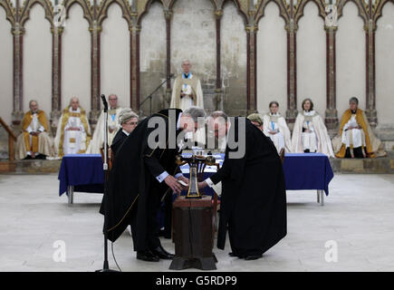 Receiver General, Brigadier John Meardon (left) and a representative from the Crown Office formally seal the documents following the election of the new Archbishop of Canterbury following a meeting of The College of Canons of Canterbury Cathedral to formally elect the 105th Archbishop of Canterbury, a process by the cathedral community dating back 1,000 years. Stock Photo