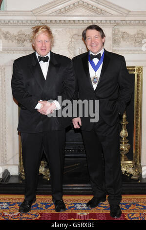 Mayor of the City of London Roger Gifford (right) and Mayor of London Boris Johnson (left) pose for a group photograph during the Lord Mayor of the City of London's annual London Government Dinner at Mansion House, London. Stock Photo