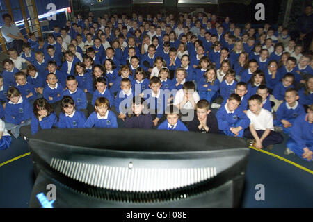 Children from Broughshane Primary school in Northern Ireland watch the Queen Mother's funeral on television.