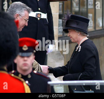 Her Majesty Queen Elizabeth II shakes hands with the Dean of Westminster Abbey, Doctor Wesley Carr as she arrives at Westminster Abbey for the funeral of her mother Queen Elizabeth the Queen, The Queen Mother. *After the service, the Queen Mother's coffin will be taken to St George's Chapel in Windsor, where she will be laid to rest next to her husband, King George VI. Stock Photo