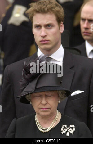 Britain's Queen Elizabeth II and Prince William watch as Queen Elizabeth the Queen Mother's coffin is driven from Westminster Abbey, London. After the service, the Queen Mother's coffin will be taken to St George's Chapel in Windsor. *..., where she will be laid to rest next to her husband, King George VI. Stock Photo