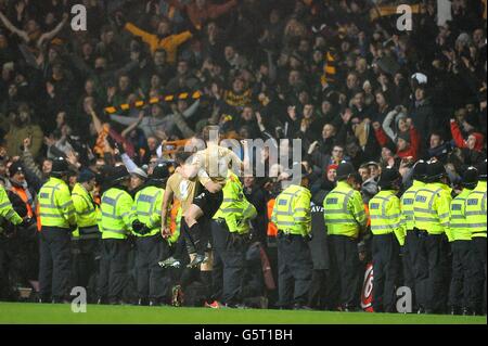 Bradford City's Stephen Darby (right) and James Hanson (left) celebrate in front of away fans and police after the final whistle Stock Photo