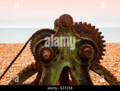 Rusty old winch machinery on beach Stock Photo