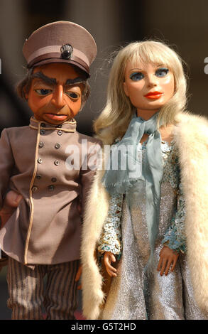 Thunderbirds puppets Lady Penelope and Parker outside Planet Hollywood, central London. The puppets are part of the 'At The Movies' film and entertainment auction. The Lady Penelope puppet is expected to fetch at least 20,000. *...with Parker and FAB1 pink Rolls Royce he drives estimated to fech 15,000 each. Stock Photo