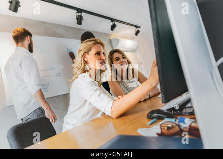 Designers working on a project and discussing new ideas Stock Photo