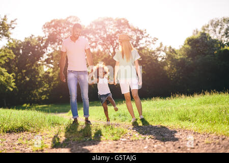 Family taking a walk in nature in a beautiful park Stock Photo