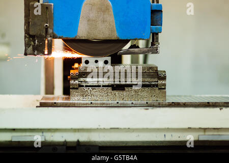 Polishing surface of metal in factory with sparkles showing during process Stock Photo
