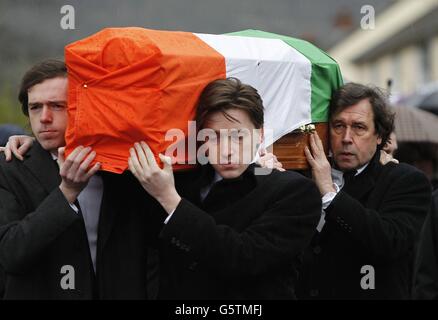 Dolours Price's coffin is carried from her family home Slievegallion Drive in Andersontown West Belfast by her two sons Danny and Oscar at front and her ex partner actor Stephen Rea (rear right) to St Agnes Church and then onto Milltown Cemetery for burial. Stock Photo