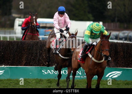 Third Intention ridden by Joe Tizzard (right) is beaten on the run in by Captain Conan ridden by Barry Geraghty in the Betfred Mobile Lotto Challengers Novices Steeple Chase during the Betfred Masters Day at Sandown Park Racecourse, Surrey. Stock Photo