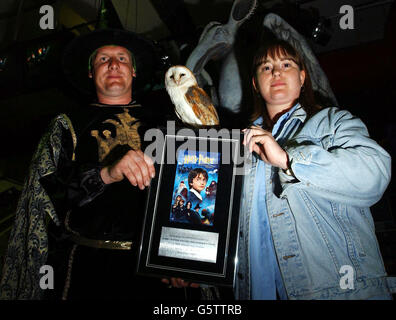 31-year-old, Toni Preece (right), from Eltham, south east London is presented with a plaque, certifying her purchase of the very first copy in Britain of the new Harry Potter DVD which went on sale at HMV, Oxford Street, London. Toni had queued for 15 hours as the Harry Potter and the Philosopher's Stone videos and DVDs hit the shops, with countrywide sales of more than one million expected on the first day alone. Stock Photo