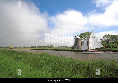 A yacht tacking on the River Bure by Oby Mill near Upton, Norfolk, England, United Kingdom. Stock Photo