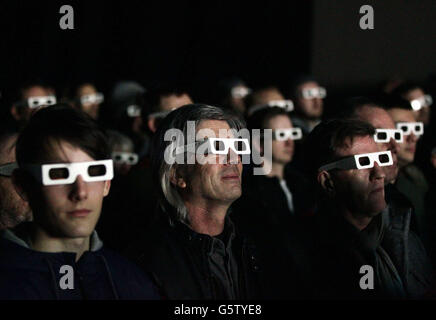 The audience wearing 3-D glasses watching German electronic music pioneers Kraftwerk performing in the Turbine Hall of Tate Modern, in London. Stock Photo