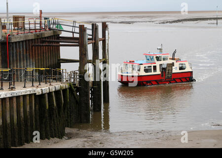 The passenger ferry from Knott End to Fleetwood approaching the pier at Fleetwood at low tide. Stock Photo