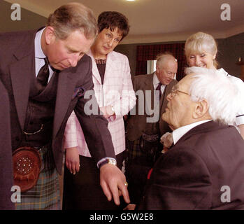 The Prince of Wales admires veteran resident John How's medals during a tour of Alastrean House in Aberdeenshire, the care home operated by the Royal Air Force for former members which accommodates up to 58 residents. Stock Photo
