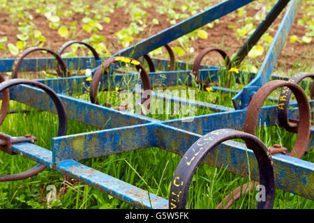 Close-up of an old metal plough lying abandoned on an allotment Stock Photo