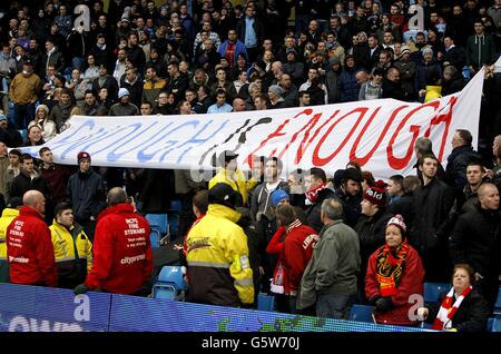 Liverpool fans with a banner aimed at both Manchester clubs in the stands Stock Photo