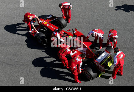 Formula One - Testing Day Two - Circuito de Jerez. Mechanics push Felipe Massa's Ferrari back in to the garage during testing at Circuito de Jerez, Jerez, Spain. Stock Photo