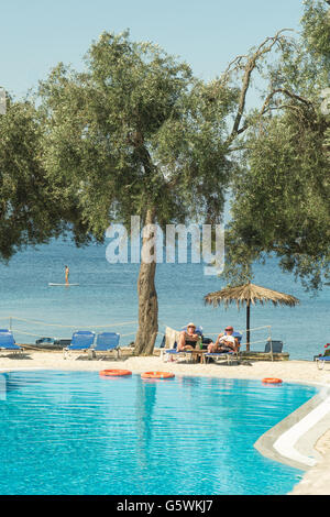 Paxos - people relaxing at the free swimming pool at Bastas Taverna Manadendri Monodendri beach, Greece, Europe and paddle board Stock Photo